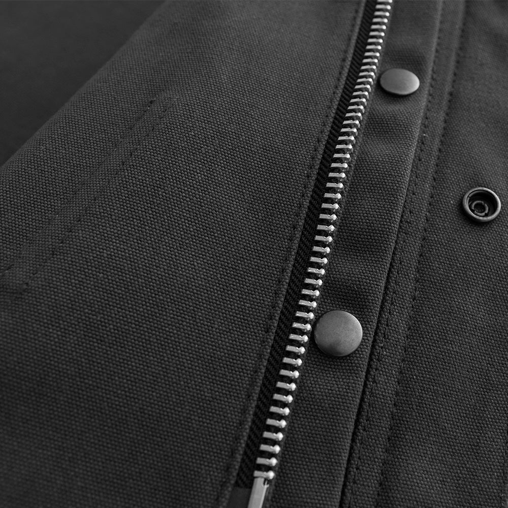 A close up of a concealed carry pocket zipper on a First Manufacturing Lowside Twill - Men's Motorcycle Twill Vest (Black).