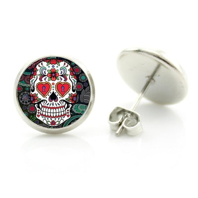 These Sugar Skull Stud Earrings are showcased on a white background, highlighting their unique and intricate design. Perfect for any occasion, these captivating jewelry pieces añd a touch of boldness to your attire.